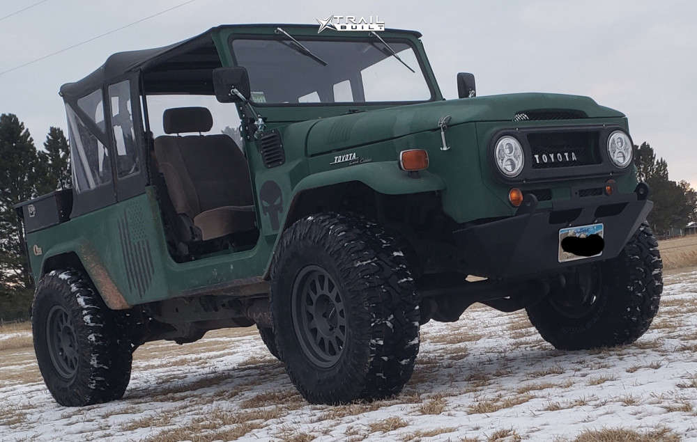 profile view of green toyota land cruiser with stock suspension